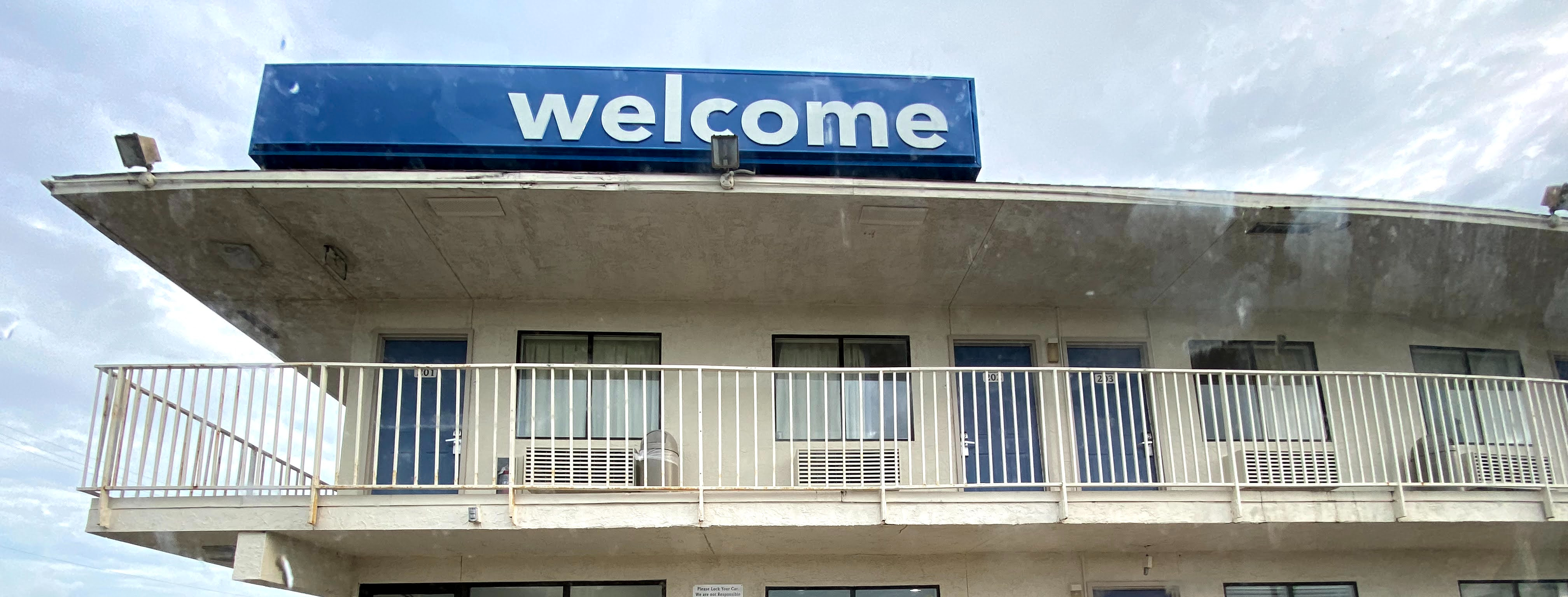 motel with a welcome sign on the roof